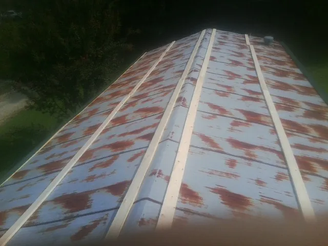 Rusted metal roof panels with new wood purlins before replacement — Storm Damage Roof Repair in Wartrace by Roofing Brothers